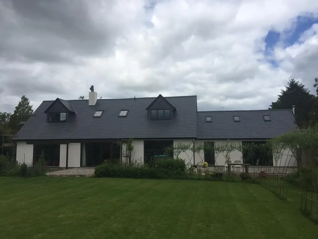 Re-roofed dormer bungalow with new slate roof by Carl Dunn Building & Roofing, Cambridge