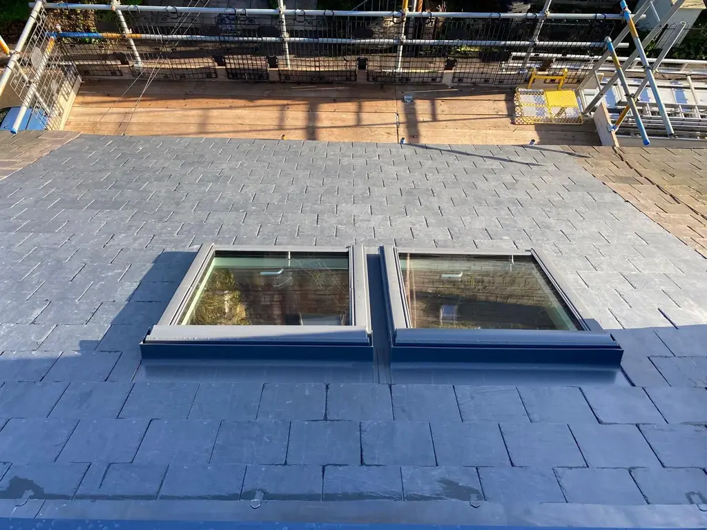 Conservation style roof windows in a slate roof by Carl Dunn Building & Roofing, Cambridge