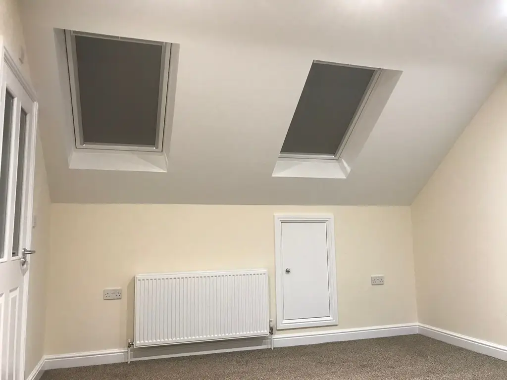 Finished loft room with roof windows and fitted blinds by Carl Dunn Building & Roofing, Cambridge