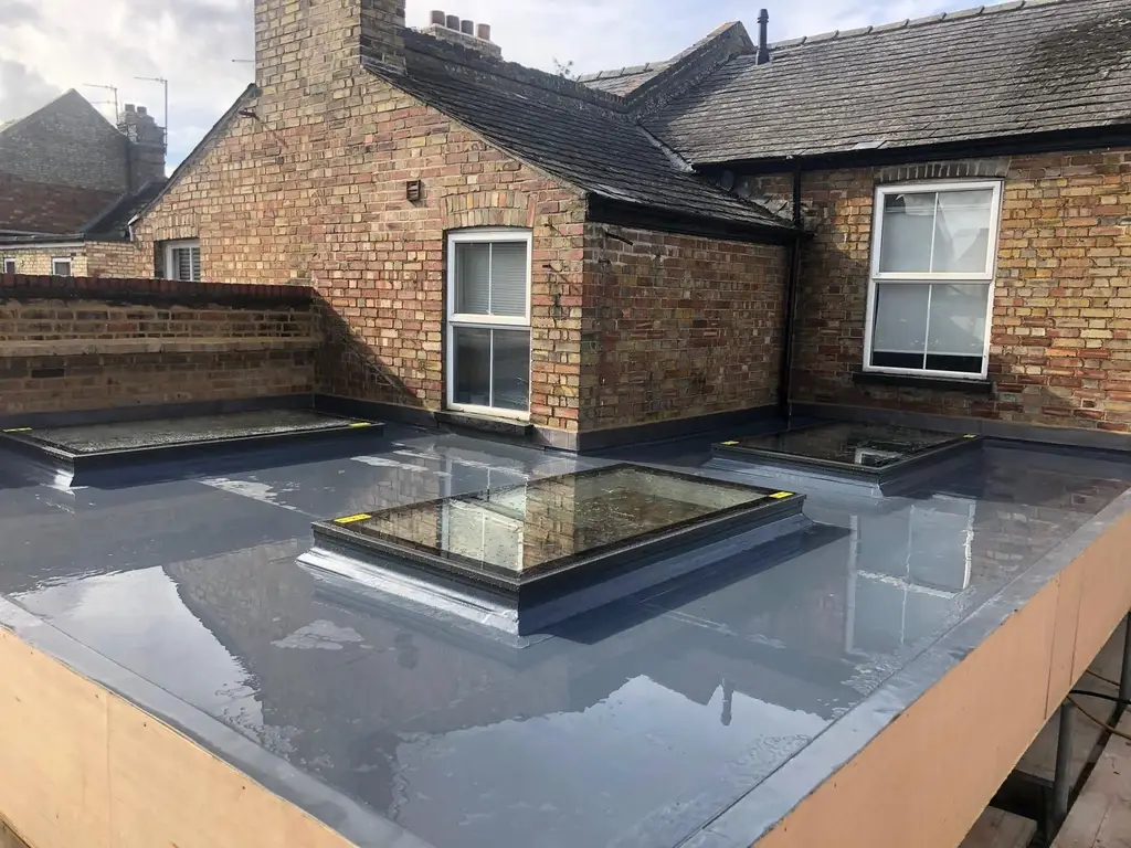Flat rooflight on a new flat roof between brick walls by Carl Dunn Building & Roofing, Cambridge