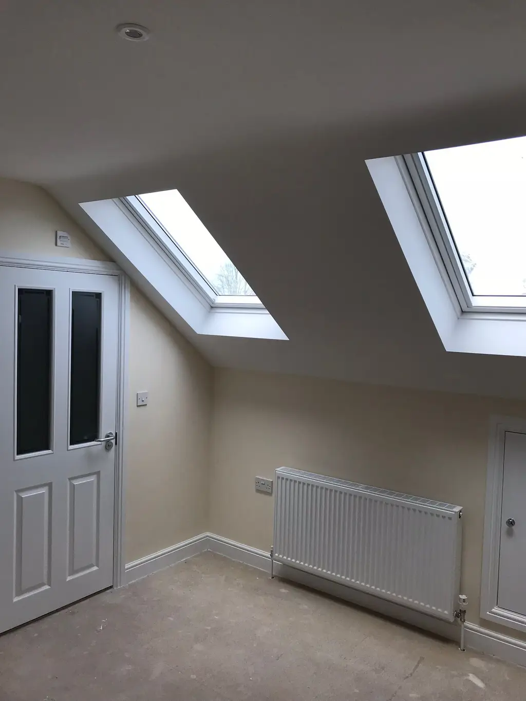Converted loft room with two roof windows letting in daylight by Carl Dunn Building & Roofing, Cambridge