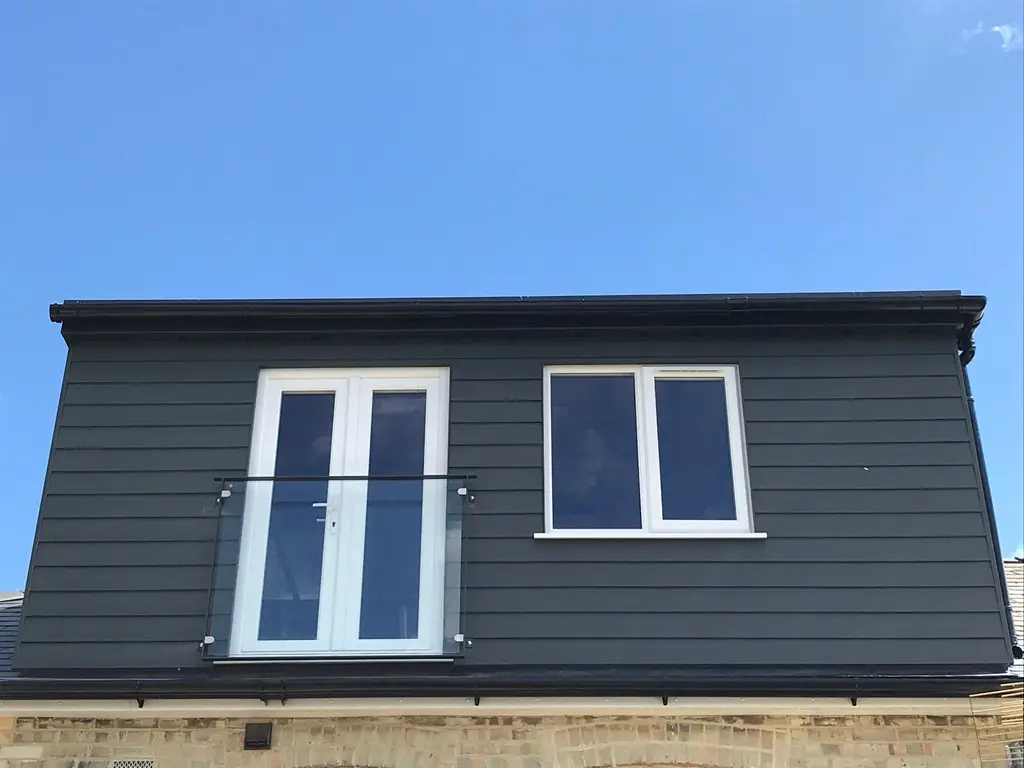 Rear dormer with French doors and glass Juliet balcony by Carl Dunn Building & Roofing, Cambridge