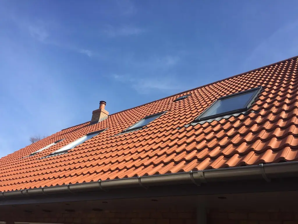 Red clay tiled roof with new roof windows fitted by Carl Dunn Building & Roofing, Cambridge