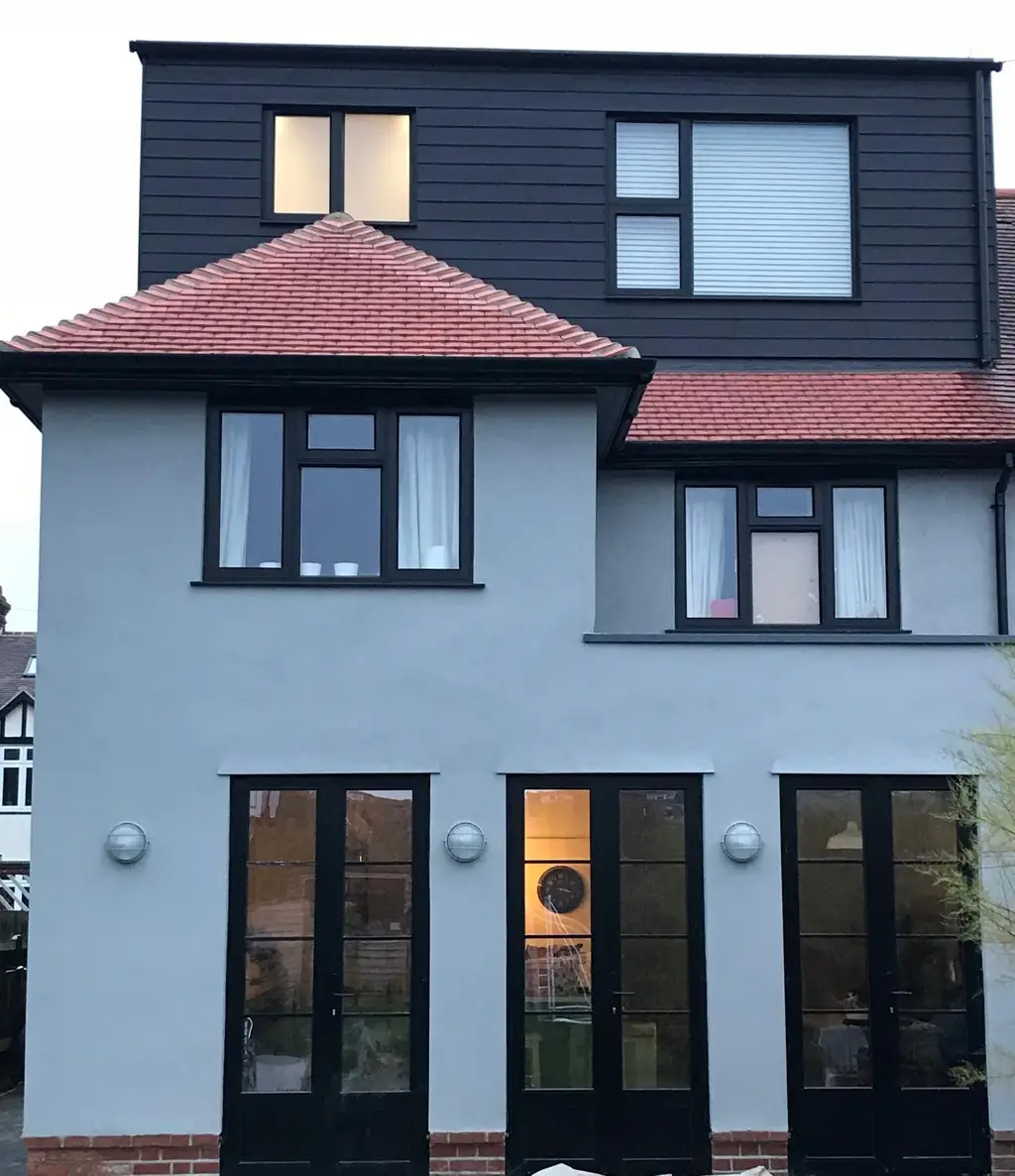 Rendered rear extension with dark window frames by Carl Dunn Building & Roofing, Cambridge