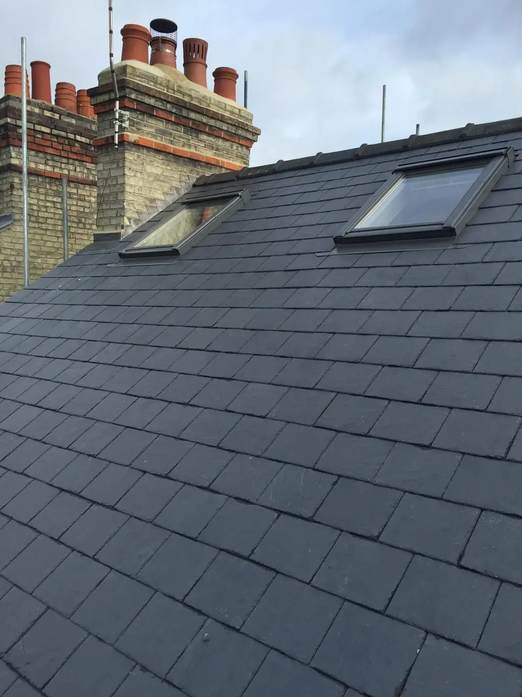 Slate roof with two roof windows by Carl Dunn Building & Roofing, Cambridge