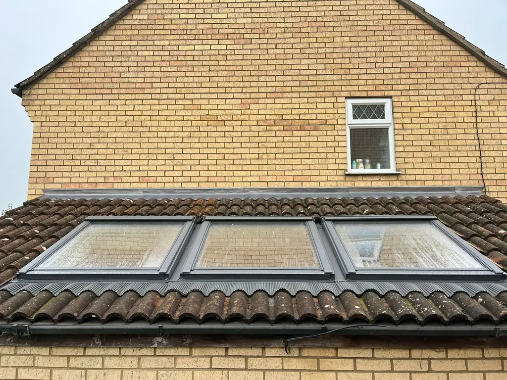 Three roof windows in a row on a pantile roof by Carl Dunn Building & Roofing, Cambridge