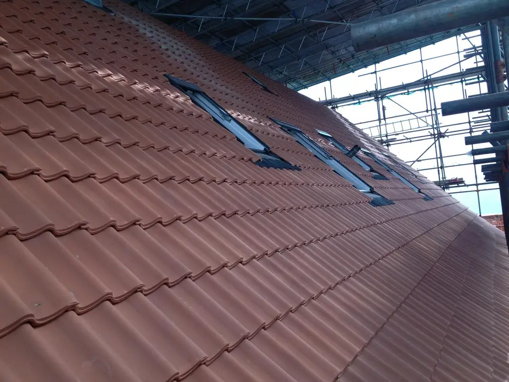 Tiled roof with roof windows under scaffolding by Carl Dunn Building & Roofing, Cambridge